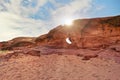 Little arc or small rock window formation in Wadi Rum desert, bright sun shines above Royalty Free Stock Photo