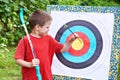 Little archer with bow pull out arrow from aim