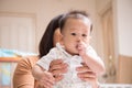 Little Asain baby boy 7 months with thumb finger in the mouth Royalty Free Stock Photo