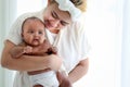 Little Asian African newborn baby girl in the embrace of her mom, portrait of sweet adorable infant in arms of mother, parent Royalty Free Stock Photo