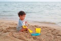 Little asian baby boy playing sand at beach alone Royalty Free Stock Photo