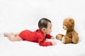 Little asian baby boy in red infant bodysuit and teddy bear on white background.Concept holiday Christmas, happy new year, infants Royalty Free Stock Photo