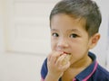 Little Asian baby girl eating fruit, pomelo, by herself Royalty Free Stock Photo