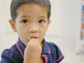 Little Asian baby girl eating fruit, pomelo, by herself Royalty Free Stock Photo