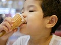 Little Asian baby girl enjoy eating ice cream cone Royalty Free Stock Photo