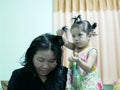 Little Asian baby girl giving her aunty`s hairs done