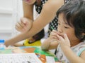 Little Asian baby girl learning to write numbers at home Royalty Free Stock Photo