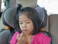 Little Asian baby girl looking at her own boogers after picking her nose - child habit / behavior Royalty Free Stock Photo