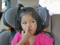 Little Asian baby girl picking her nose - child habit / behavior