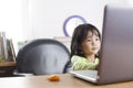 Little Asian baby girl working on a laptop Royalty Free Stock Photo