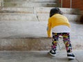 Asian baby girl, 2 years old, learning to climb up the stairs by herself Royalty Free Stock Photo