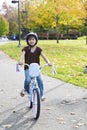 Little Asian biracial girl riding bike in park Royalty Free Stock Photo