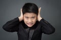 Little asian boy in black suit upset, depression face Royalty Free Stock Photo