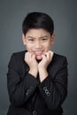 Little asian boy in black suit upset, depression face Royalty Free Stock Photo