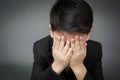 Little asian boy in black suit upset, depression face Royalty Free Stock Photo