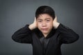 Little asian boy in black suit upset, depression face Royalty Free Stock Photo