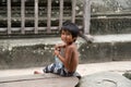 Little asian boy with bottle of water posing in Angkor Wat temple