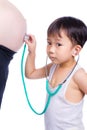 Little asian boy examining pregnant mother's tummy Royalty Free Stock Photo