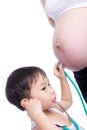 Little asian boy examining pregnant mother's tummy Royalty Free Stock Photo