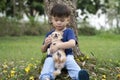 Little Asian boy happy with a Chihuahua dog in the park, Children and pet Royalty Free Stock Photo