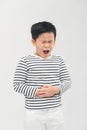 A little Asian boy has a stomachache. Holding his belly with both hands Royalty Free Stock Photo