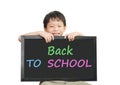 Little Asian boy holding chalkboard over white background Royalty Free Stock Photo