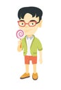 Little asian boy holding a lollipop candy.