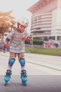 Little Boy is learning to Skate on an Rollerblade in park with full protection gear and helmet Royalty Free Stock Photo