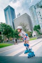 Little Boy is learning to Skate on an Rollerblade in park with full protection gear and helmet