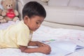 A little asian boy paint on white book Royalty Free Stock Photo