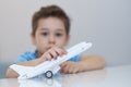 Little asian boy is playing with toy plastic airplane. Royalty Free Stock Photo