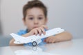 Little asian boy is playing with toy plastic airplane. Royalty Free Stock Photo