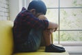 LIttle Asian boy sad and depressed sitting in the room next the window Royalty Free Stock Photo