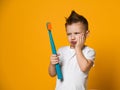 Little Asian boy suffering from toothache - Dental problem. Royalty Free Stock Photo