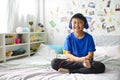 Little asian boy using headphones and smiling happy while listening music on bed Royalty Free Stock Photo