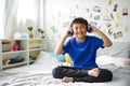 Little asian boy using headphones and smiling happy while listening music Royalty Free Stock Photo