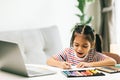 little asian child drawing with color pencils on table at home Royalty Free Stock Photo