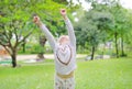 Little Asian child girl Arms up her hands and looking up in the summer garden Royalty Free Stock Photo