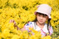 Little asian child girl have fun with a happy at the morning garden natural blooming yellow flowers, Cute girl children kids Royalty Free Stock Photo