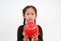 Little Asian child girl holding round silicone inflatable red knobby ball on white background