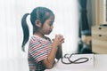 Little asian child girl praying with rosary at home Royalty Free Stock Photo