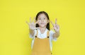 Little asian child girl showing finger number eight isolated on yellow background. Kid counting with fingers for education concept Royalty Free Stock Photo