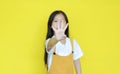 Little asian child girl showing finger number four isolated on yellow background. Kid counting with fingers for education concept Royalty Free Stock Photo