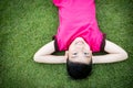 Little Asian child laying down on the grass Royalty Free Stock Photo