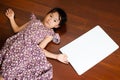Little Asian child laying down on the wooden background with a b Royalty Free Stock Photo