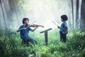 Little Asian child playing violin at outdoors Royalty Free Stock Photo