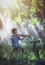 Little Asian child playing violin at outdoors Royalty Free Stock Photo