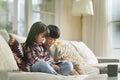 two cute little asian kids using digital tablet at home Royalty Free Stock Photo