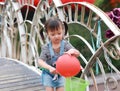 Aisa cute naughty lovely child girl play with balloon have fun outdoor in summer park happy smile happiness funny childhood Royalty Free Stock Photo