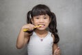 Little asian cute girl brush teeth .